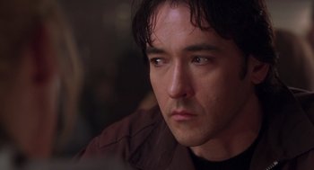 Movie still from “High Fidelity” (2000), directed by Stephen Frears – A man's face as he stares into the distance; Close Up shot, Over the shoulder angle