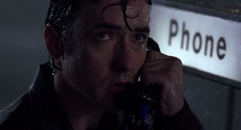 Movie still from “High Fidelity” (2000), directed by Stephen Frears – A person talking on a cell phone; Close Up shot, Low angle