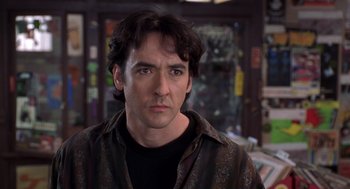 Movie still from “High Fidelity” (2000), directed by Stephen Frears – A person wearing a shirt; Close Up shot, Over the shoulder angle