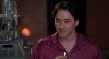 Movie still from “High Fidelity” (2000), directed by Stephen Frears – A person holding a glass of wine; Close Up shot, Over the shoulder angle