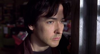 Movie still from “High Fidelity” (2000), directed by Stephen Frears – A person wearing a jacket; Close Up shot, Low angle