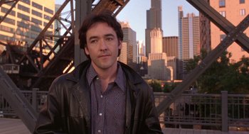 Movie still from “High Fidelity” (2000), directed by Stephen Frears – A person wearing a leather jacket; Close Up shot, Over the shoulder angle