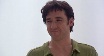 Movie still from “High Fidelity” (2000), directed by Stephen Frears – A person wearing a green shirt; Close Up shot, Low angle