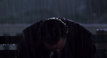 Movie still from “High Fidelity” (2000), directed by Stephen Frears – A man with his head down in the rain; Close Up shot, Low angle