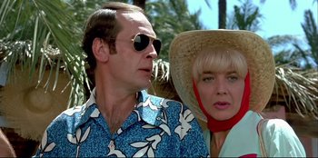 Movie still from “High Heels” (1991), directed by Pedro Almodóvar – A man and a woman wearing sun glasses and hats; Close Up shot, Low angle