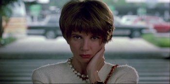 Movie still from “High Heels” (1991), directed by Pedro Almodóvar – A person wearing a necklace; Close Up shot, Low angle