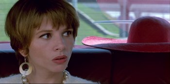Movie still from “High Heels” (1991), directed by Pedro Almodóvar – A person sitting in a car; Close Up shot, Low angle