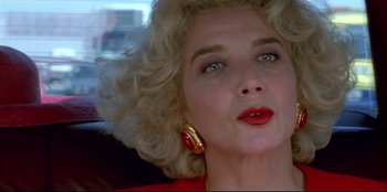 Movie still from “High Heels” (1991), directed by Pedro Almodóvar – A person wearing a red dress; Close Up shot, Low angle
