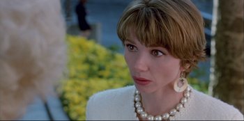 Movie still from “High Heels” (1991), directed by Pedro Almodóvar – A person wearing a necklace; Close Up shot, Over the shoulder angle