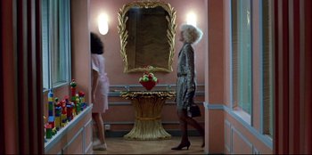 Movie still from “High Heels” (1991), directed by Pedro Almodóvar – Two women are standing in front of a mirror in a room; Wide shot, Low angle