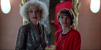 Movie still from “High Heels” (1991), directed by Pedro Almodóvar – Two women standing next to each other in front of a mirror; Close Up shot, Low angle