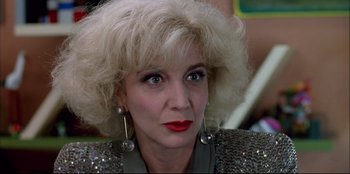 Movie still from “High Heels” (1991), directed by Pedro Almodóvar – A person wearing a dress; Close Up shot, Low angle