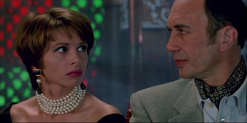 Movie still from “High Heels” (1991), directed by Pedro Almodóvar – A man and a woman wearing pearl necklaces; Close Up shot, Over the shoulder angle