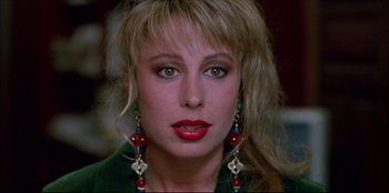 Movie still from “High Heels” (1991), directed by Pedro Almodóvar – A person wearing a green shirt; Close Up shot, Over the shoulder angle