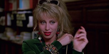 Movie still from “High Heels” (1991), directed by Pedro Almodóvar – A person wearing a green shirt; Close Up shot, Over the shoulder angle