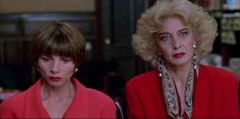 Movie still from “High Heels” (1991), directed by Pedro Almodóvar – Two women sitting next to each other in a room; Close Up shot, Low angle
