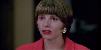 Movie still from “High Heels” (1991), directed by Pedro Almodóvar – A person wearing a pink jacket; Close Up shot, High angle