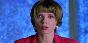 Movie still from “High Heels” (1991), directed by Pedro Almodóvar – A person with short brown hair; Close Up shot, Low angle