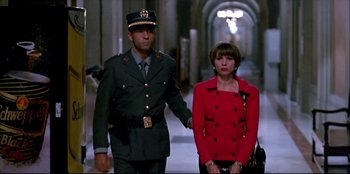 Movie still from “High Heels” (1991), directed by Pedro Almodóvar – A man and a woman are walking in a hallway; Medium shot, Low angle