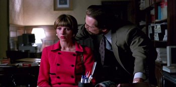 Movie still from “High Heels” (1991), directed by Pedro Almodóvar – A man and a woman in a red dress; Close Up shot, Over the shoulder angle