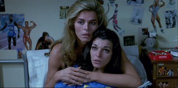 Movie still from “High Heels” (1991), directed by Pedro Almodóvar – A woman and a woman hugging each other in a room; Close Up shot, High angle