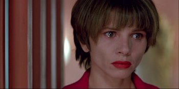 Movie still from “High Heels” (1991), directed by Pedro Almodóvar – A person with short brown hair; Close Up shot, High angle