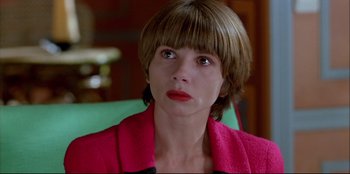 Movie still from “High Heels” (1991), directed by Pedro Almodóvar – A person wearing a pink jacket; Close Up shot, High angle