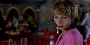 Movie still from “High Heels” (1991), directed by Pedro Almodóvar – A person wearing a pink shirt; Close Up shot, Low angle