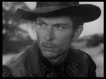 Movie still from “High Noon” (1952), directed by Fred Zinnemann – Black and white photograph of a man wearing a cowboy hat; Close Up shot, Low angle