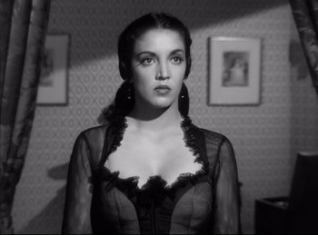 A black and white photo of a woman in a black dress