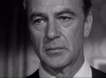 Movie still from “High Noon” (1952), directed by Fred Zinnemann – Black and white photograph of a man in a suit; Close Up shot, Low angle