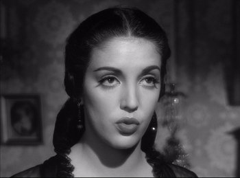 Movie still from “High Noon” (1952), directed by Fred Zinnemann – A black and white photo of a woman with long black hair; Close Up shot, Low angle