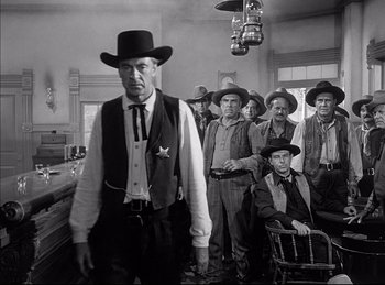 Movie still from “High Noon” (1952), directed by Fred Zinnemann – A group of men standing in front of each other; Medium shot, Low angle
