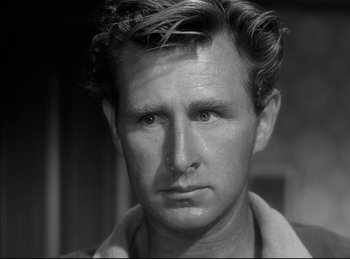 Movie still from “High Noon” (1952), directed by Fred Zinnemann – An old black and white photo of a man's face; Close Up shot, Over the shoulder angle
