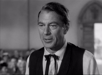 Movie still from “High Noon” (1952), directed by Fred Zinnemann – Black and white photograph of a man wearing a vest and tie; Close Up shot, Over the shoulder angle