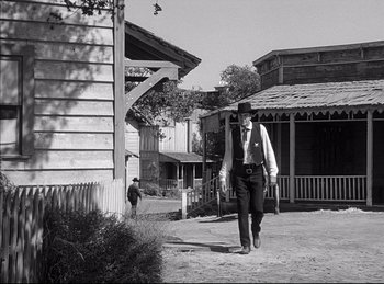 Movie still from “High Noon” (1952), directed by Fred Zinnemann – An old man walking down the street in a western town; Wide shot, Low angle
