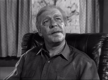 Movie still from “High Noon” (1952), directed by Fred Zinnemann – An older man sitting in a chair looking up; Close Up shot, Low angle