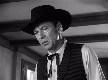 Movie still from “High Noon” (1952), directed by Fred Zinnemann – A black and white photo of a man wearing a black hat; Close Up shot, Low angle