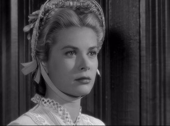 Movie still from “High Noon” (1952), directed by Fred Zinnemann – A black - and - white photo of a woman in a victorian dress; Close Up shot, Low angle