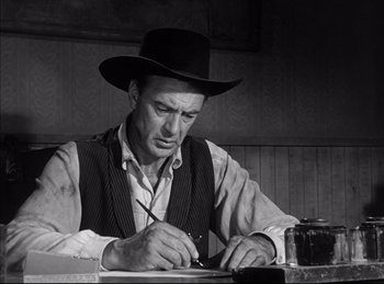 Movie still from “High Noon” (1952), directed by Fred Zinnemann – A man wearing a cowboy hat writing on a piece of paper; Medium shot, Low angle