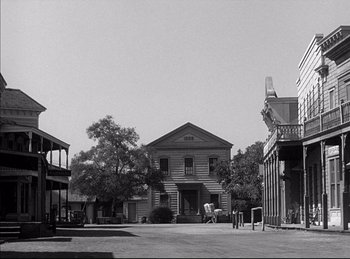 Movie still from “High Noon” (1952), directed by Fred Zinnemann – An old photo of an old western town with horse and carriage; Extreme Wide shot, Low angle