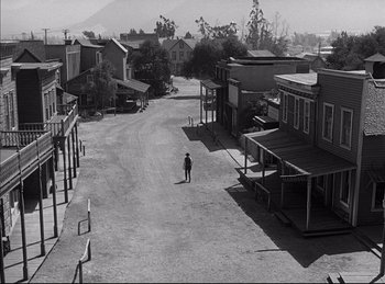Movie still from “High Noon” (1952), directed by Fred Zinnemann – An old photo of an empty street in a western town; Extreme Wide shot, High angle