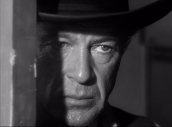 Movie still from “High Noon” (1952), directed by Fred Zinnemann – A black and white photo of a man in a hat; Close Up shot, Low angle