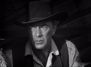 Movie still from “High Noon” (1952), directed by Fred Zinnemann – A black and white photo of a man wearing a cowboy hat; Close Up shot, Low angle