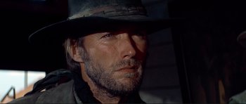 Movie still from “High Plains Drifter” (1973), directed by Clint Eastwood – A person wearing a hat; Close Up shot, Low angle