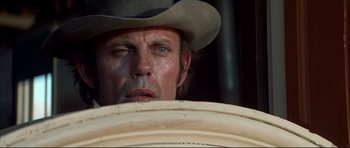 Movie still from “High Plains Drifter” (1973), directed by Clint Eastwood – A person wearing a cowboy hat; Close Up shot, Low angle
