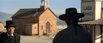 Movie still from “High Plains Drifter” (1973), directed by Clint Eastwood – A man standing in front of an old church; Extreme Wide shot, Low angle