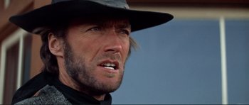 Movie still from “High Plains Drifter” (1973), directed by Clint Eastwood – A person wearing a hat; Close Up shot, Low angle