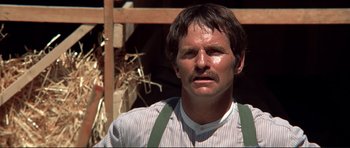 Movie still from “High Plains Drifter” (1973), directed by Clint Eastwood – A person wearing a shirt and suspenders; Close Up shot, Low angle
