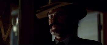 Movie still from “High Plains Drifter” (1973), directed by Clint Eastwood – A person wearing a cowboy hat; Close Up shot, Low angle